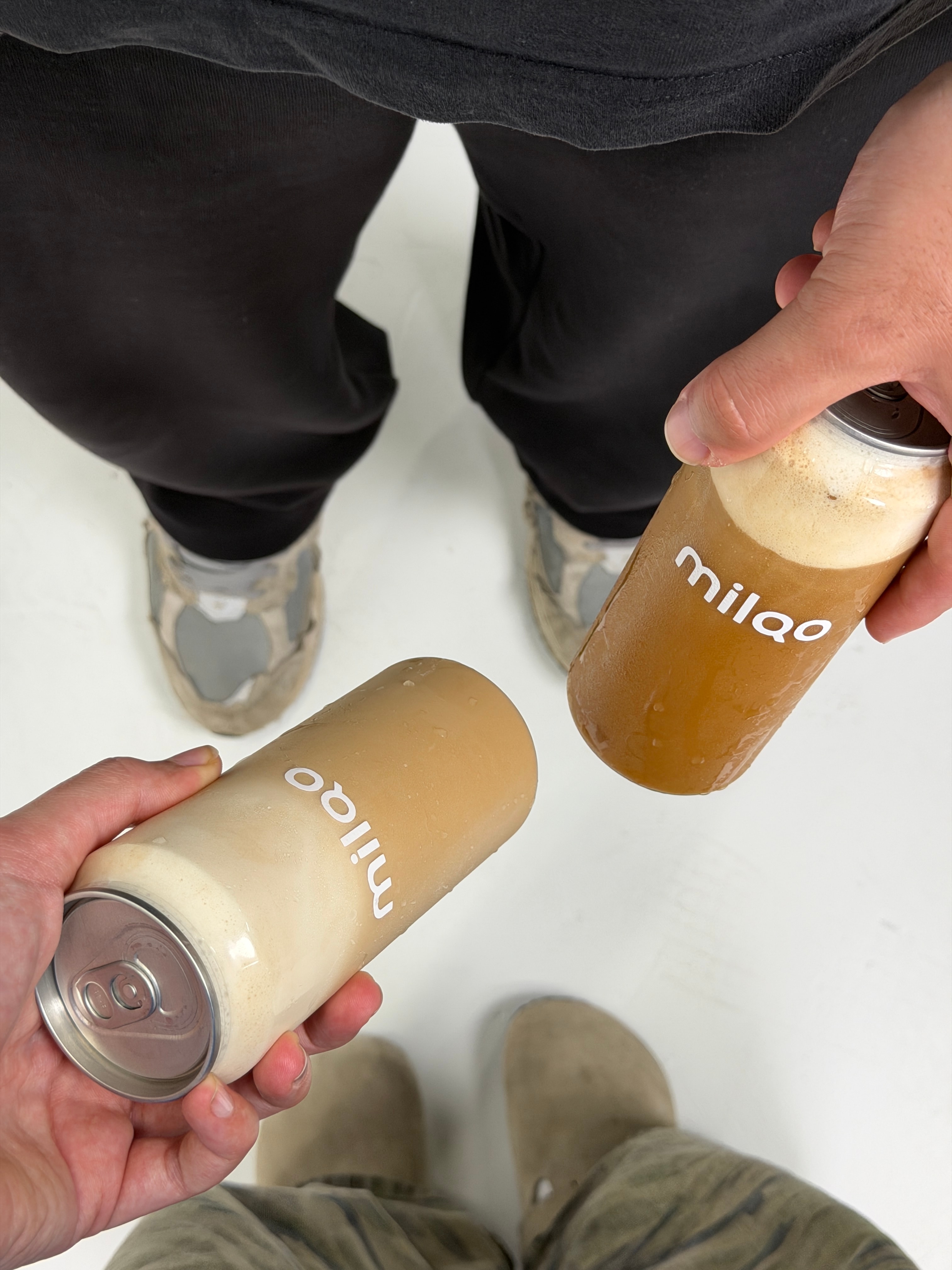 milqo iced latte cans in hand